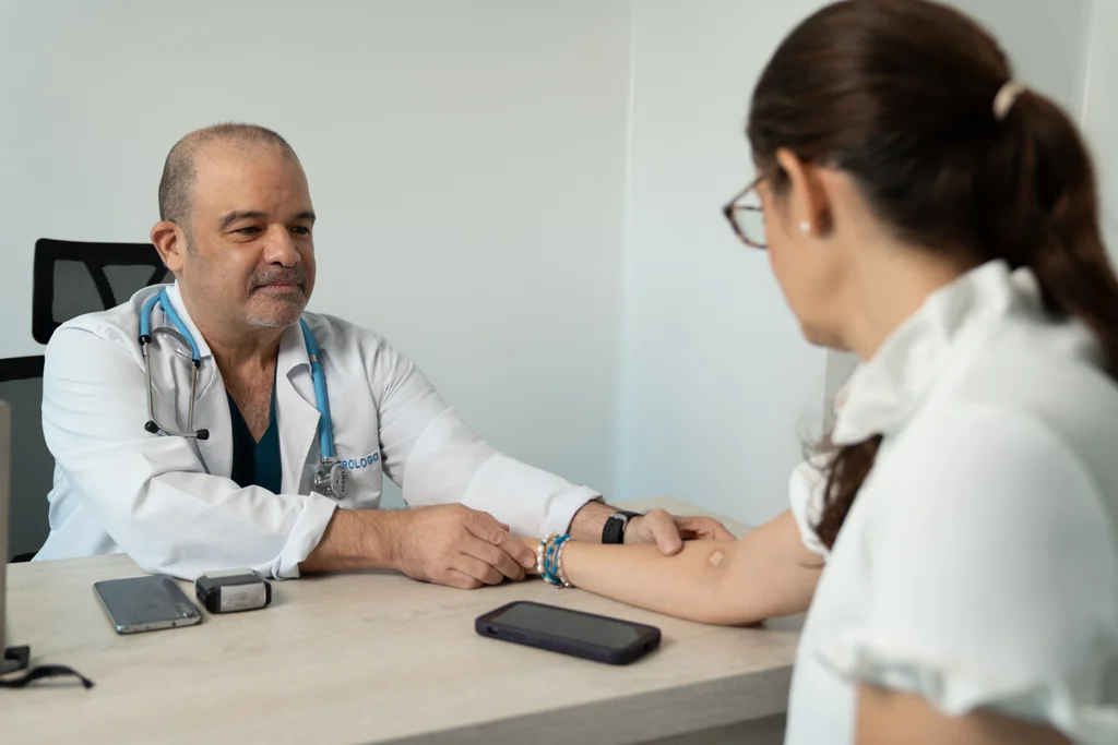 Physician measuring a participant’s blood pressure in an Allied consulting room.