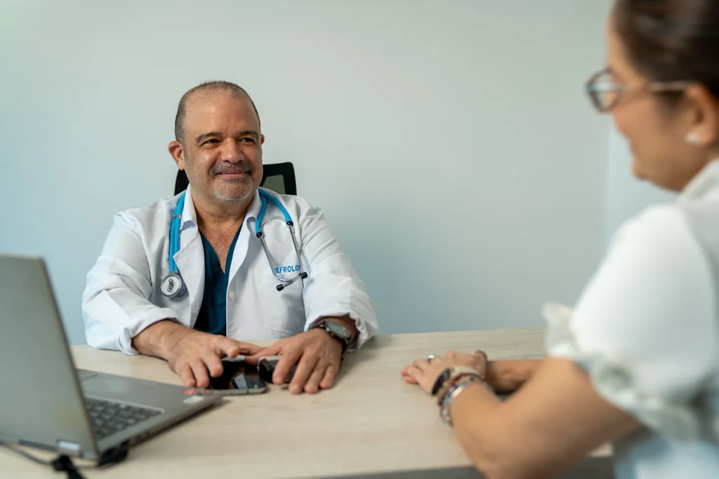 Physician speaking with a participant in an Allied consulting room.